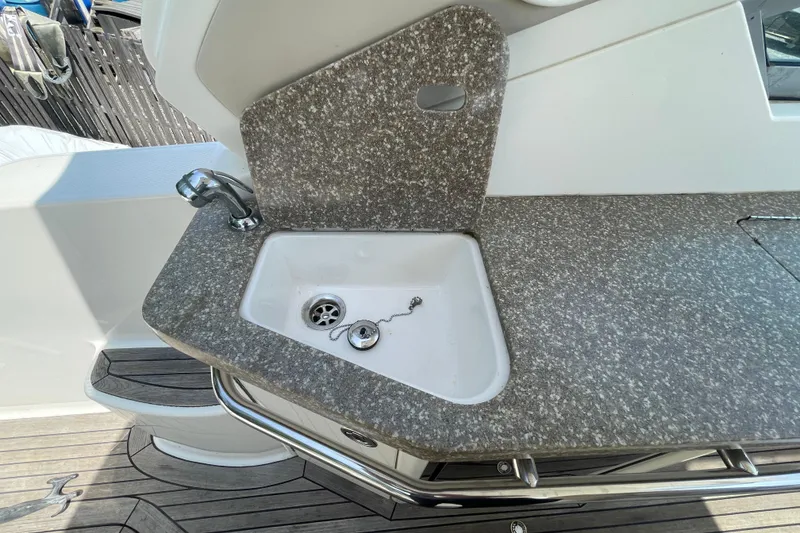 Slide: The Image of 2011 Chaparral 330 Signature boat sink with granite countertop and chrome faucet. - 41