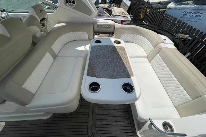 Slide: The Image of Luxurious seating area on 2011 Chaparral 330 Signature boat with table and cup holders. - 42