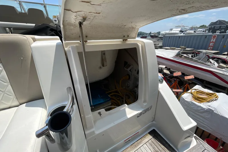 Slide: The Image of 2011 Chaparral 330 Signature boat storage compartment open, revealing interior equipment and wiring. - 46
