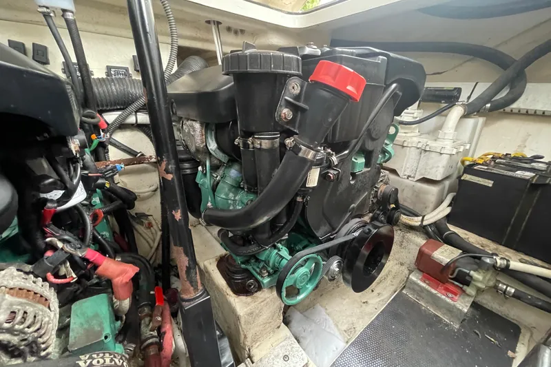 Slide: The Image of Engine compartment of a 2011 Chaparral 330 Signature boat, featuring a Volvo Penta engine. - 54