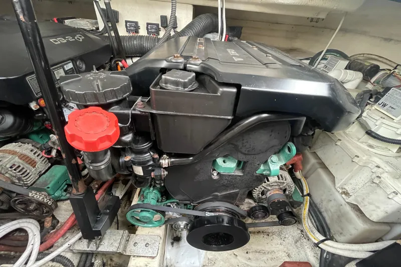Slide: The Image of Engine compartment of a 2011 Chaparral 330 Signature boat, featuring Volvo Penta components. - 55