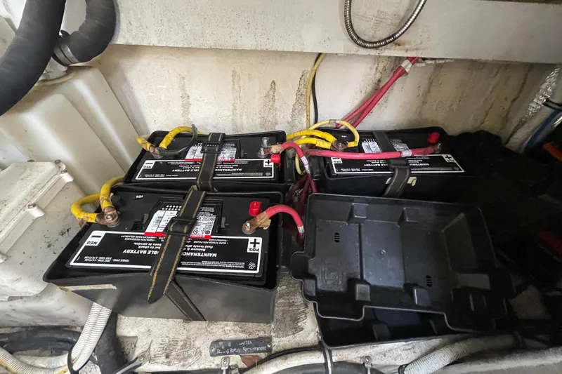 Slide: The Image of Battery compartment of a 2011 Chaparral 330 Signature boat, showing multiple connected batteries. - 56