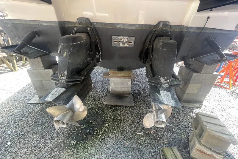 Slide: The Image of 2011 Chaparral 330 Signature boat on blocks, showing dual propellers and stern drive. - 57