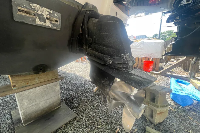 Slide: The Image of 2011 Chaparral 330 Signature boat propeller and stern drive on gravel. - 58