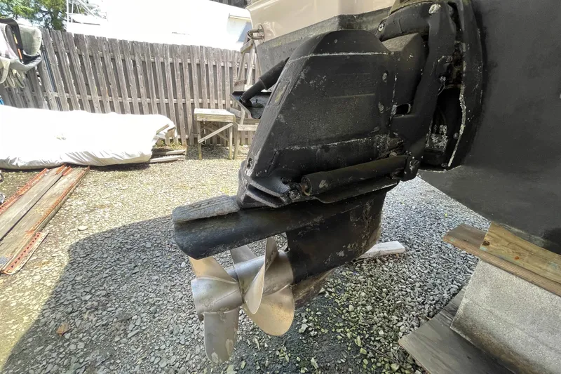 Slide: The Image of 2011 Chaparral 330 Signature boat propeller and drive system on gravel surface. - 61