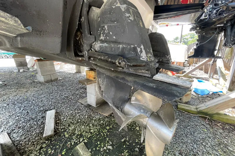 Slide: The Image of 2011 Chaparral 330 Signature boat propeller and stern drive on gravel. - 63