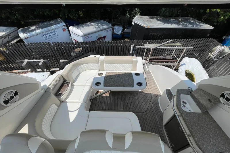 Slide: The Image of 2011 Chaparral 330 Signature boat interior with seating, table, and kitchenette. - 9