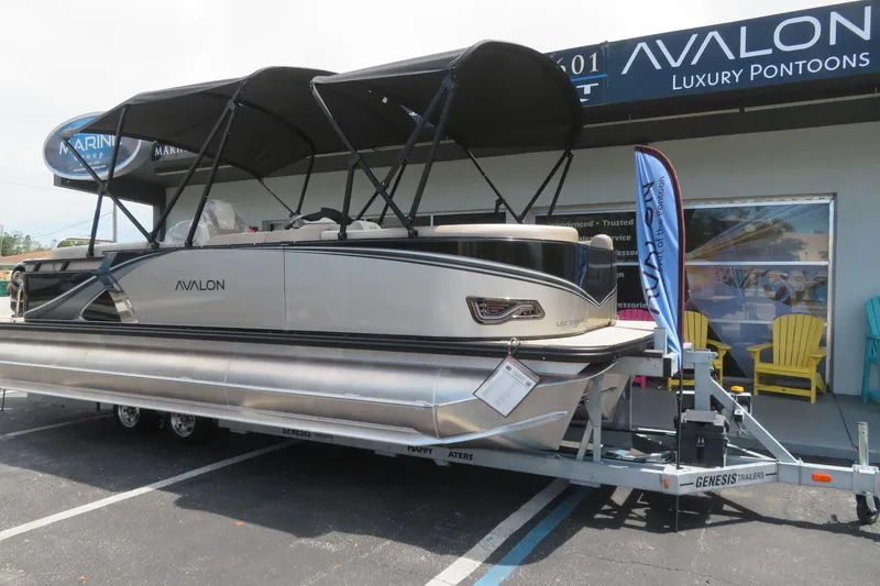 Slide: The Image of 2026 Avalon 2385 LSZ Quad Lounger luxury pontoon displayed at Sarasota dealership. - 1