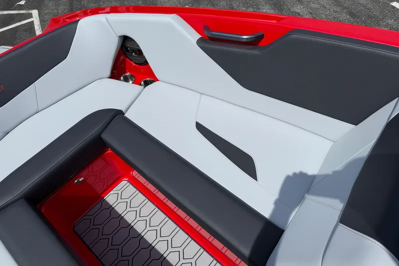 Slide: The Image of 2025 MasterCraft NXT24 boat interior with red, black, and white seating design. - 12