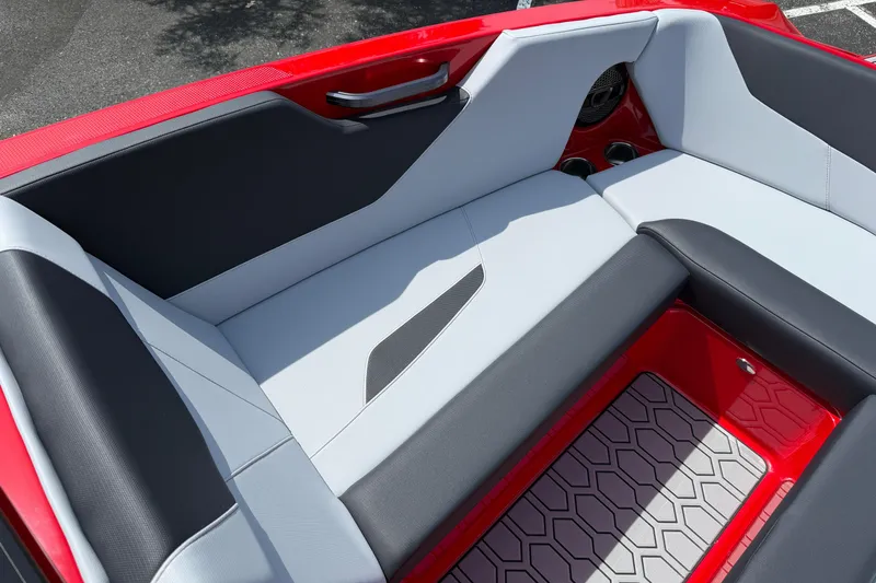 Slide: The Image of 2025 MasterCraft NXT24 boat interior with sleek red and gray seating design. - 13