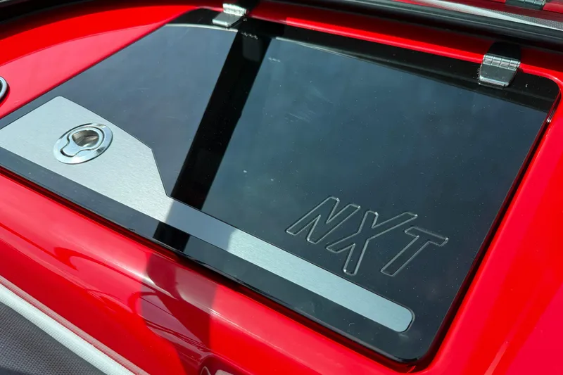 Slide: The Image of 2025 MasterCraft NXT24 boat detail with sleek red and black design. - 15