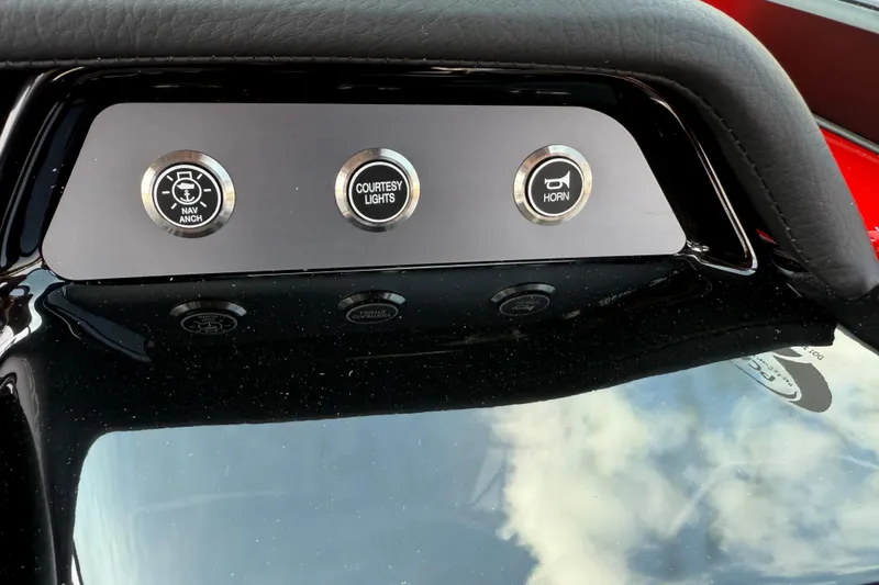 Slide: The Image of 2025 MasterCraft NXT24 dashboard with navigation, courtesy lights, and horn controls. - 23