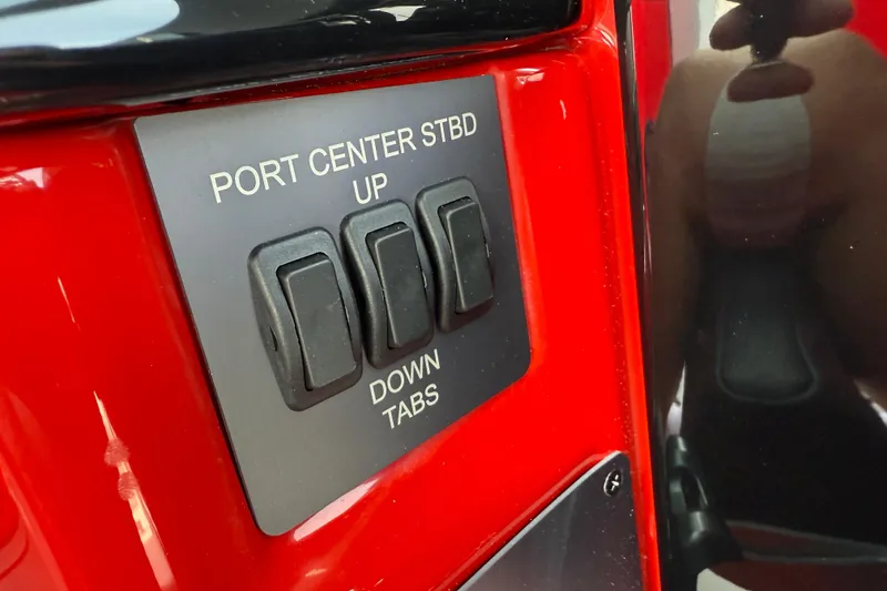 Slide: The Image of Control panel of 2025 MasterCraft NXT24 boat with switches for port, center, and starboard tabs. - 25