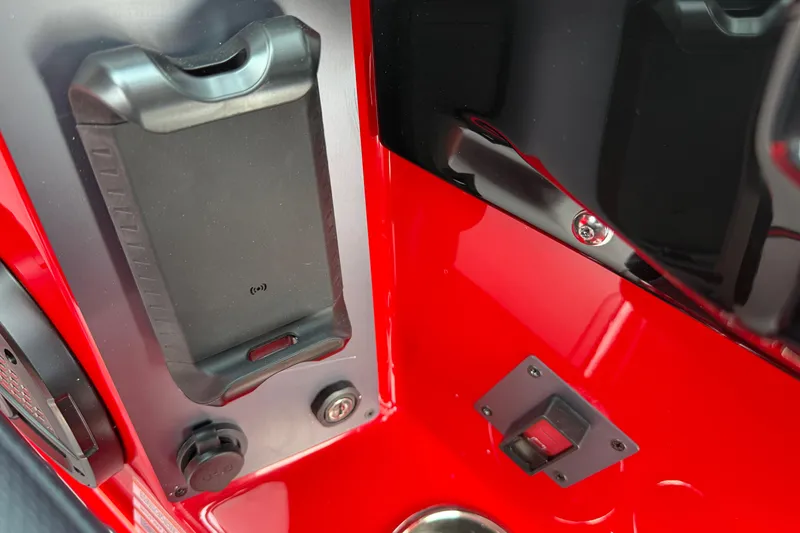 Slide: The Image of 2025 MasterCraft NXT24 interior detail with red panel and phone holder. - 26