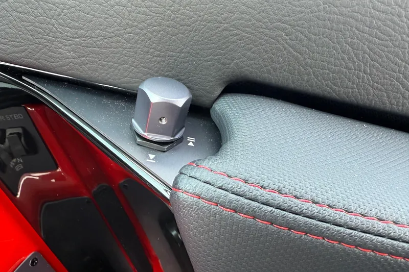 Slide: The Image of Close-up of 2025 MasterCraft NXT24 boat control knob and textured upholstery. - 27