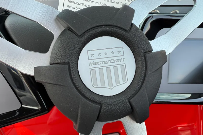 Slide: The Image of Close-up of 2025 MasterCraft NXT24 steering wheel with logo and emblem. - 28