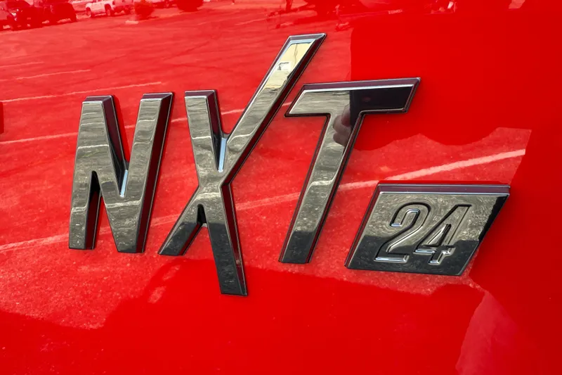 Slide: The Image of 2025 MasterCraft NXT24 logo on vibrant red background. - 3