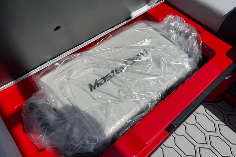 Slide: The Image of 2025 MasterCraft NXT24 engine compartment with protective cover in red casing. - 30