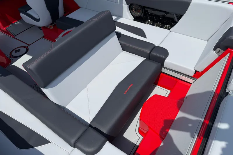 Slide: The Image of 2025 MasterCraft NXT24 boat interior with sleek, modern seating in red, black, and white. - 32