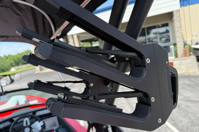 Slide: The Image of Close-up of a 2025 MasterCraft NXT24 boat's black wakeboard rack. - 33