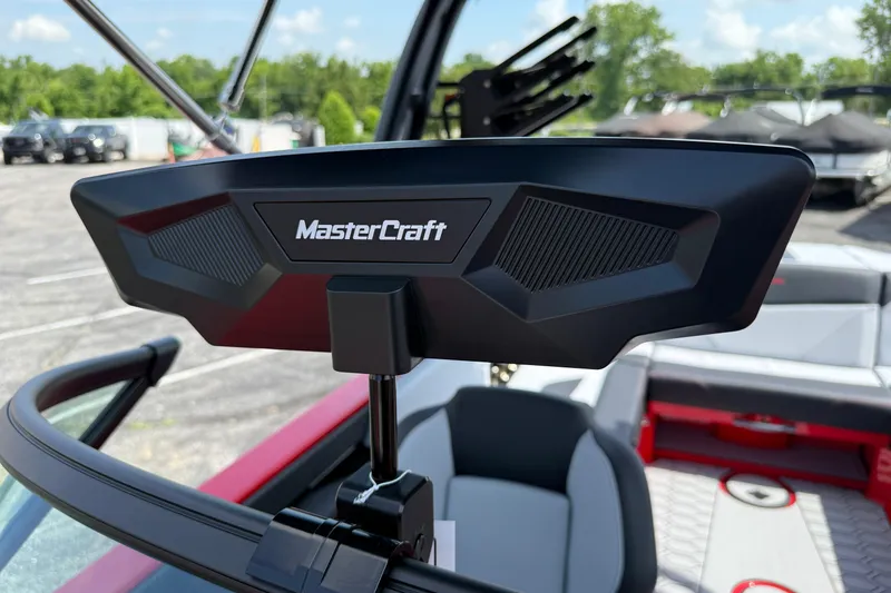 Slide: The Image of 2025 MasterCraft NXT24 boat interior with rearview mirror, showcasing sleek design and seating. - 36