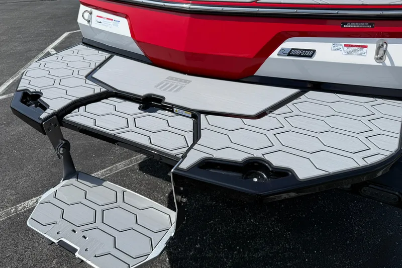 Slide: The Image of 2025 MasterCraft NXT24 boat with hexagonal-patterned swim platform and SurfStar feature. - 5