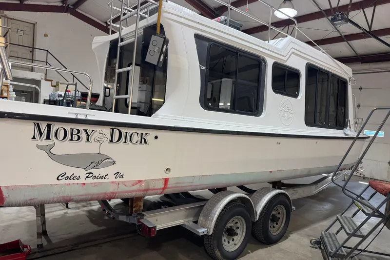 Slide: The Image of 2001 Adventure Craft 2800 Cabin Yacht "Moby Dick" on trailer in a workshop. - 1
