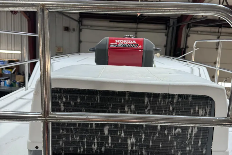 Slide: The Image of 2001 Adventure Craft 2800 Cabin Yacht with Honda generator in a garage setting. - 13