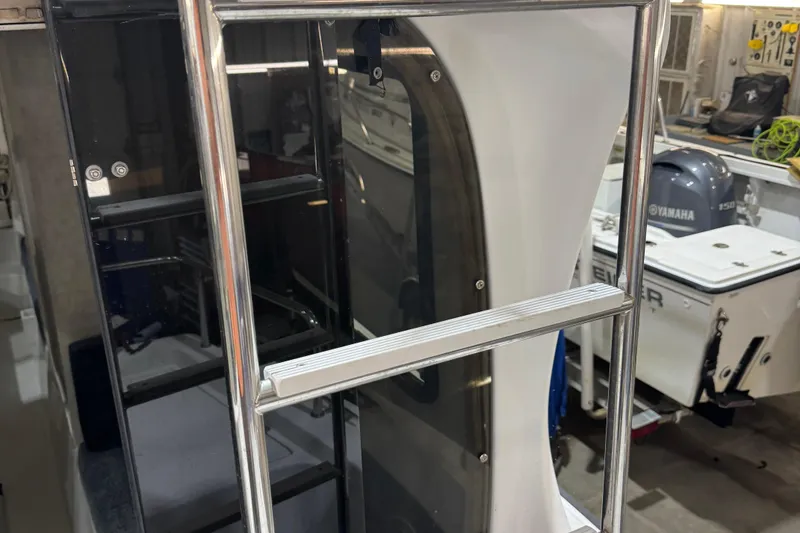 Slide: The Image of Stainless steel ladder on 2001 Adventure Craft 2800 Cabin Yacht, with Yamaha engine in background. - 3