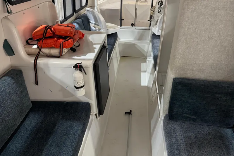 Slide: The Image of Interior of 2001 Adventure Craft 2800 Cabin Yacht with life jackets and fire extinguisher. - 4