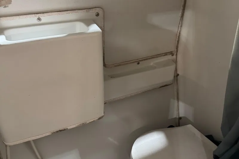 Slide: The Image of 2001 Adventure Craft 2800 Cabin Yacht bathroom with compact sink and toilet. - 5