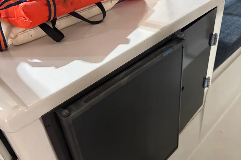 Slide: The Image of 2001 Adventure Craft 2800 Cabin Yacht interior with storage compartment and life jacket. - 7