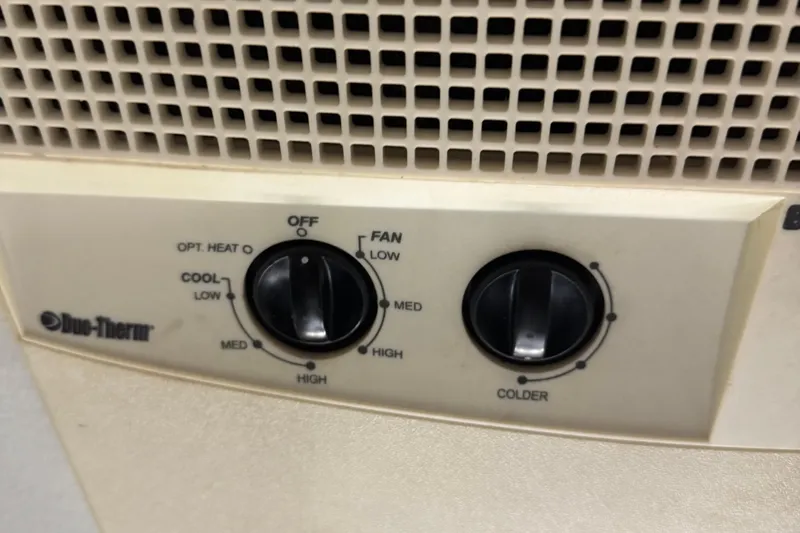 Slide: The Image of Duo-Therm control panel on 2001 Adventure Craft 2800 Cabin Yacht, featuring temperature and fan settings. - 8