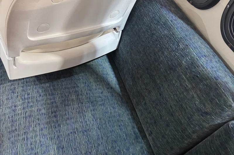 Slide: The Image of Interior seating of a 2001 Adventure Craft 2800 Cabin Yacht, featuring blue upholstery. - 9