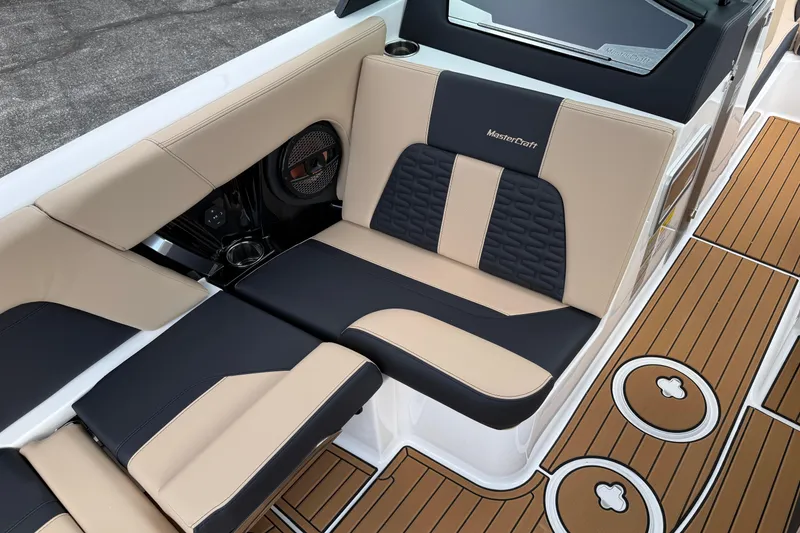 Slide: The Image of 2025 MasterCraft X24 boat interior with beige and black seating, featuring stylish design. - 12