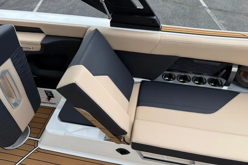 Slide: The Image of 2025 MasterCraft X24 interior seating with cup holders and modern design. - 15