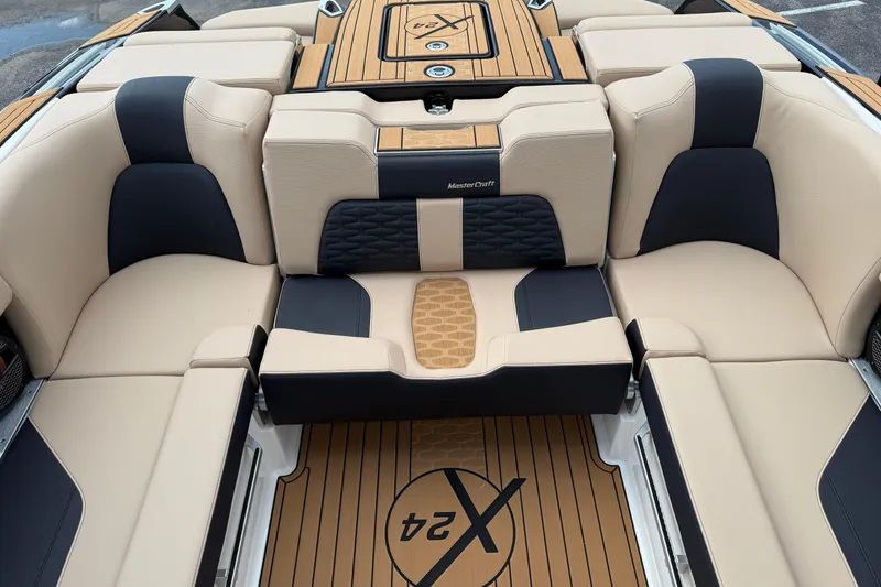 Slide: The Image of 2025 MasterCraft X24 boat interior with beige and black seating, stylish design. - 17