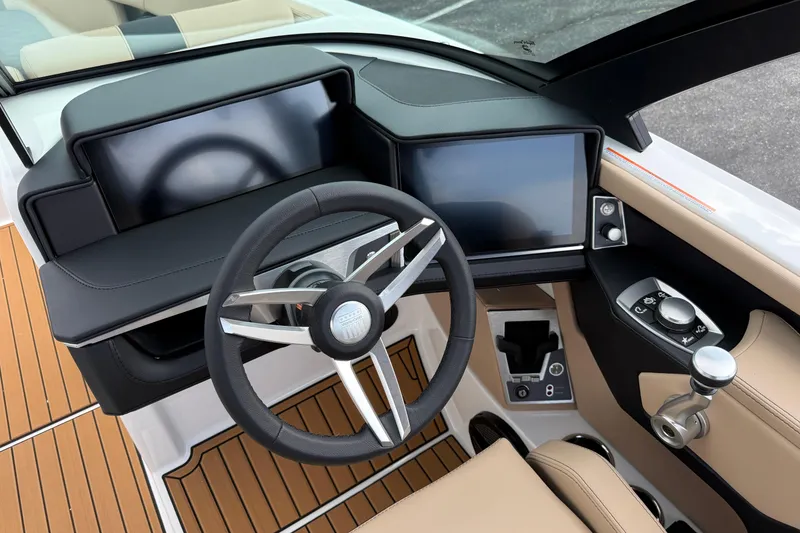 Slide: The Image of 2025 MasterCraft X24 boat dashboard with modern steering and digital controls. - 21