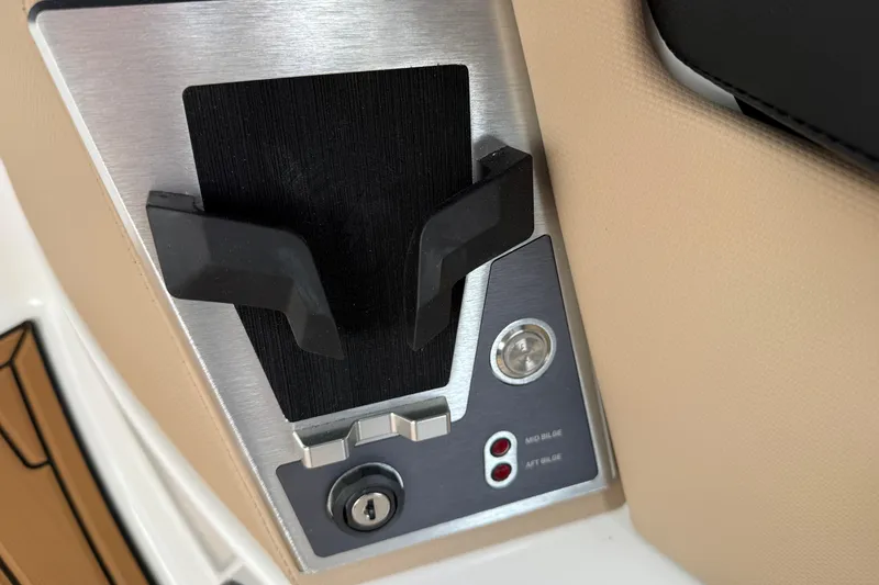 Slide: The Image of Control panel of 2025 MasterCraft X24 boat with key slot and switches. - 23