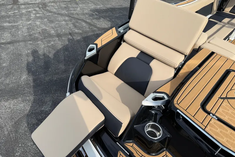 Slide: The Image of Luxurious seating on 2025 MasterCraft X24 boat with tan upholstery and cup holder. - 28