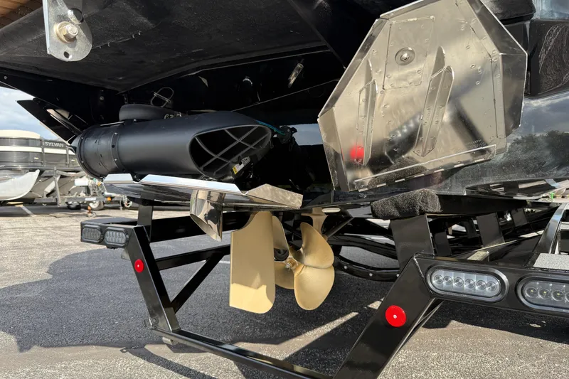 Slide: The Image of 2025 MasterCraft X24 boat underside showing propeller and trailer details. - 32