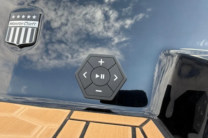 Slide: The Image of 2025 MasterCraft X24 boat control panel with logo and sky reflection. - 36