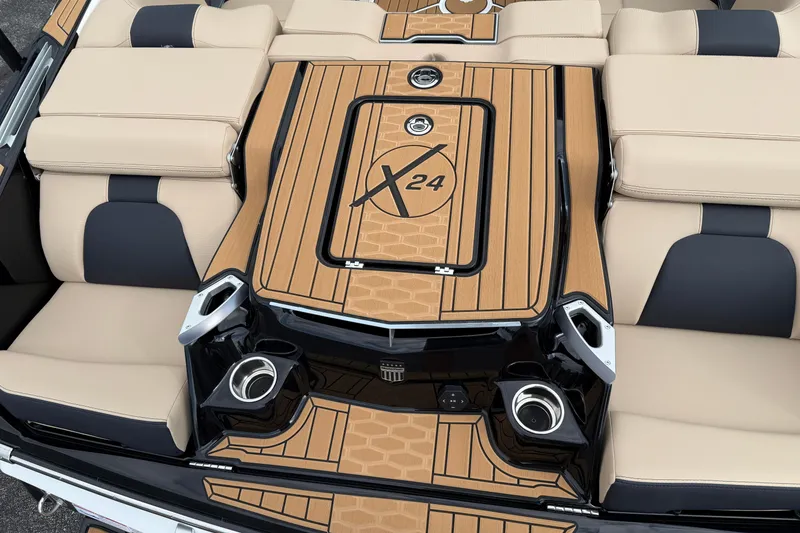Slide: The Image of 2025 MasterCraft X24 boat interior with beige and black seating, stylish deck design. - 5