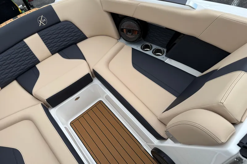 Slide: The Image of Luxurious interior of 2025 MasterCraft X24 boat with beige and navy seating. - 8