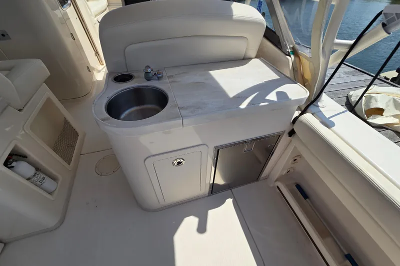 Slide: The Image of 2016 Grady-White Freedom 307 boat interior with sink and storage compartments. - 11