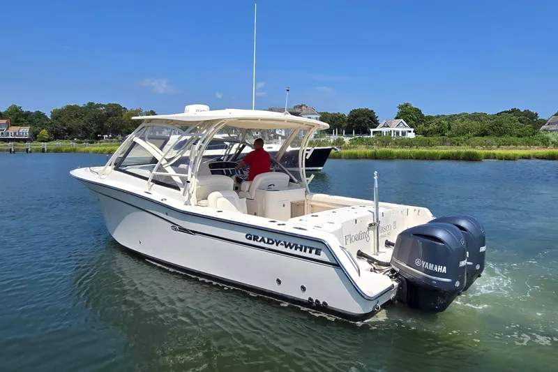 Slide: The Image of 2016 Grady-White Freedom 307 boat cruising on a scenic waterway. - 2