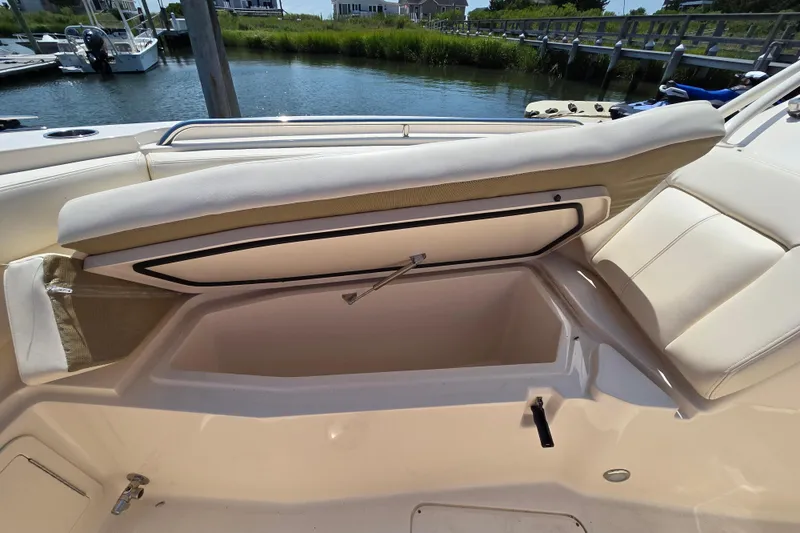 Slide: The Image of 2016 Grady-White Freedom 307 boat with open storage compartment by the water. - 20
