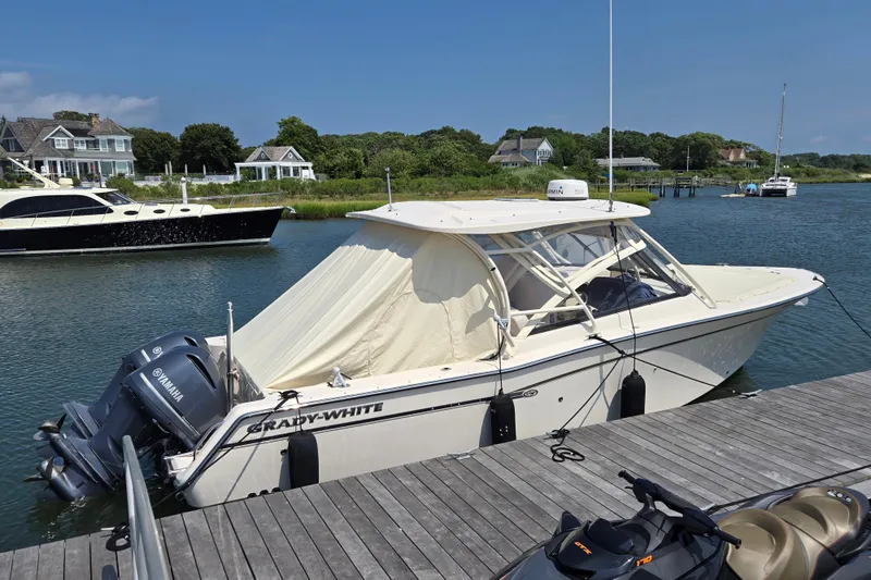 Slide: The Image of 2016 Grady-White Freedom 307 boat docked by waterfront homes, featuring Yamaha engines. - 22