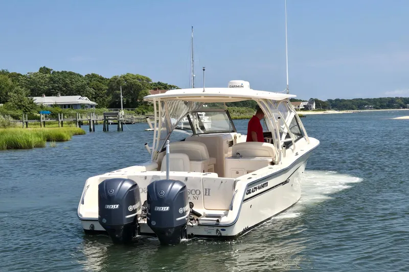 Slide: The Image of 2016 Grady-White Freedom 307 boat cruising on a scenic waterway. - 3