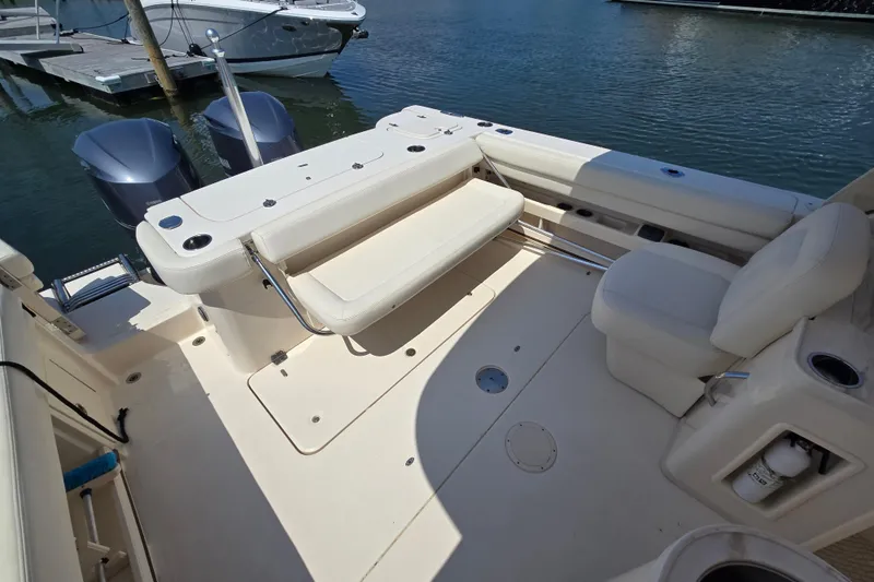 Slide: The Image of 2016 Grady-White Freedom 307 boat interior with seating and twin outboard motors. - 8
